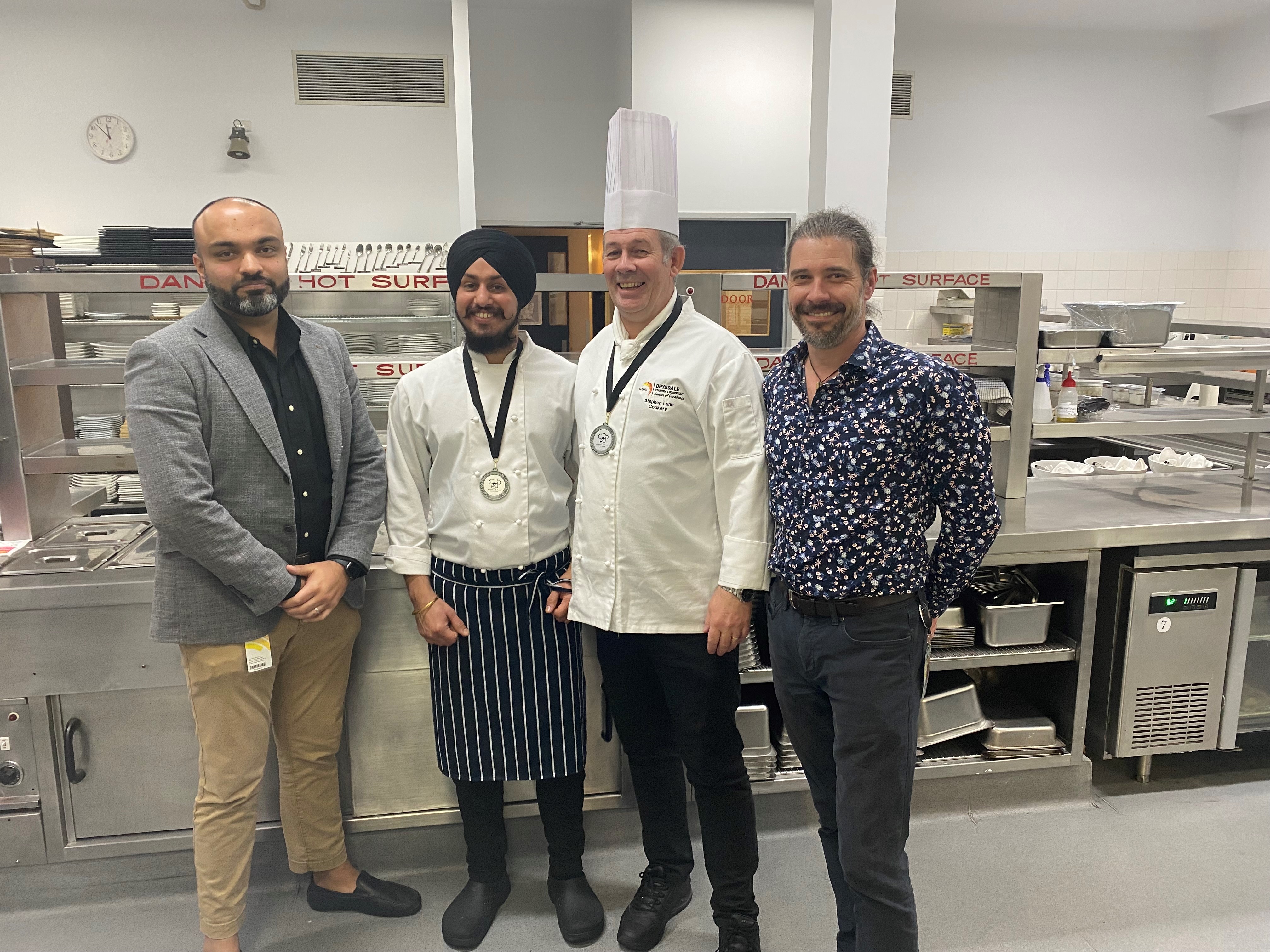 TasTAFE Drysdale cookery apprentice Lovepreet Singh with his teachers in the kitchen