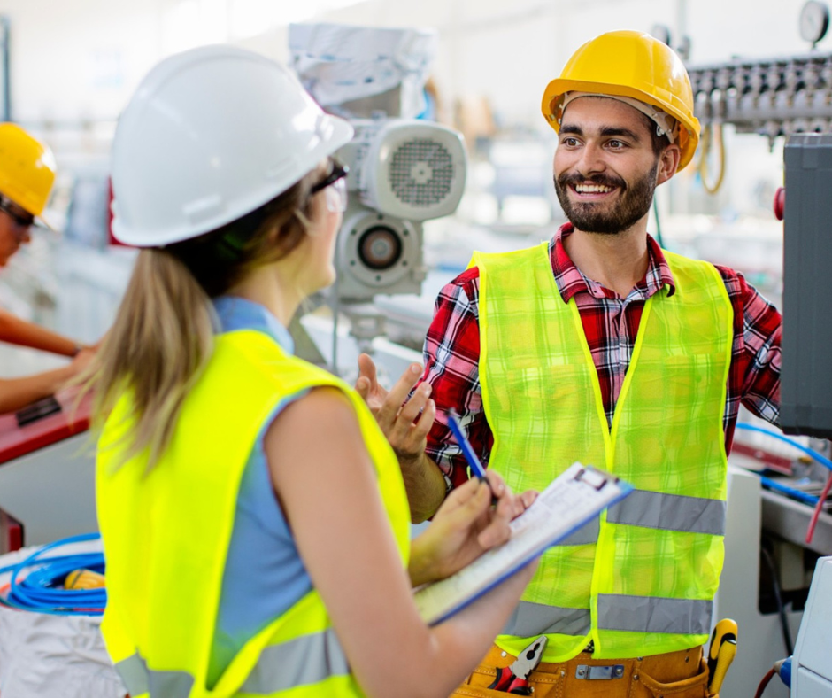 Man and woman in hi-vis talking