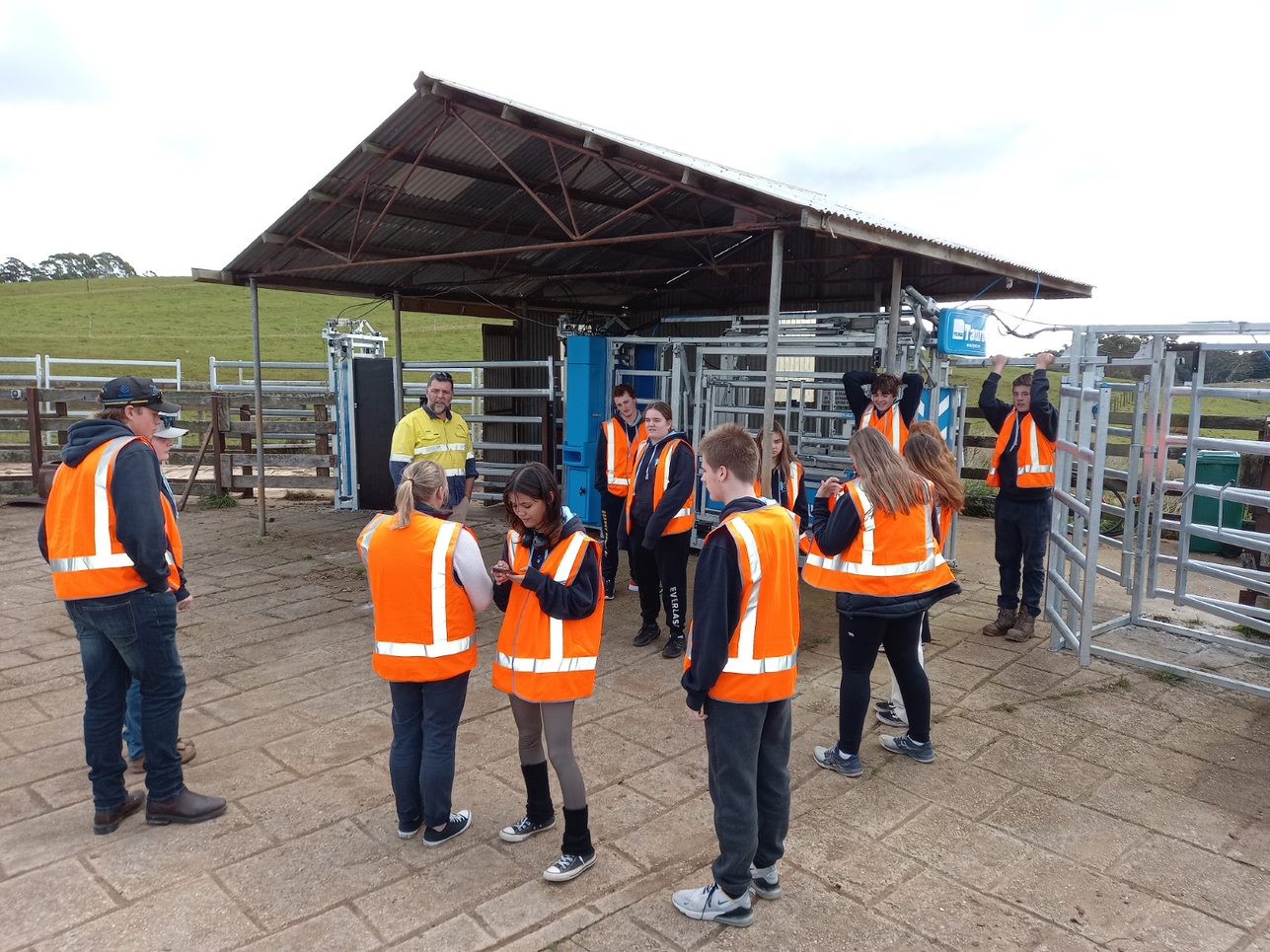 Group of students with farm in the background