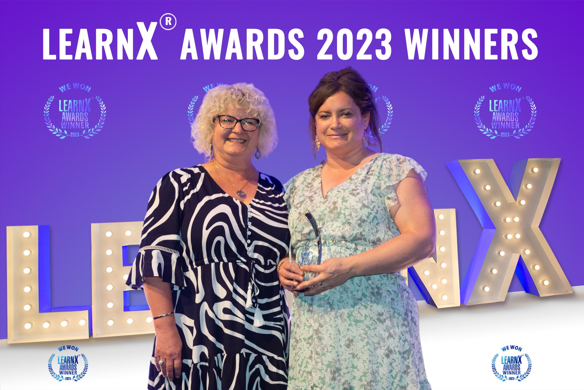 Two ladies from TasTAFE holding a trophy that they won at the learn X Awards