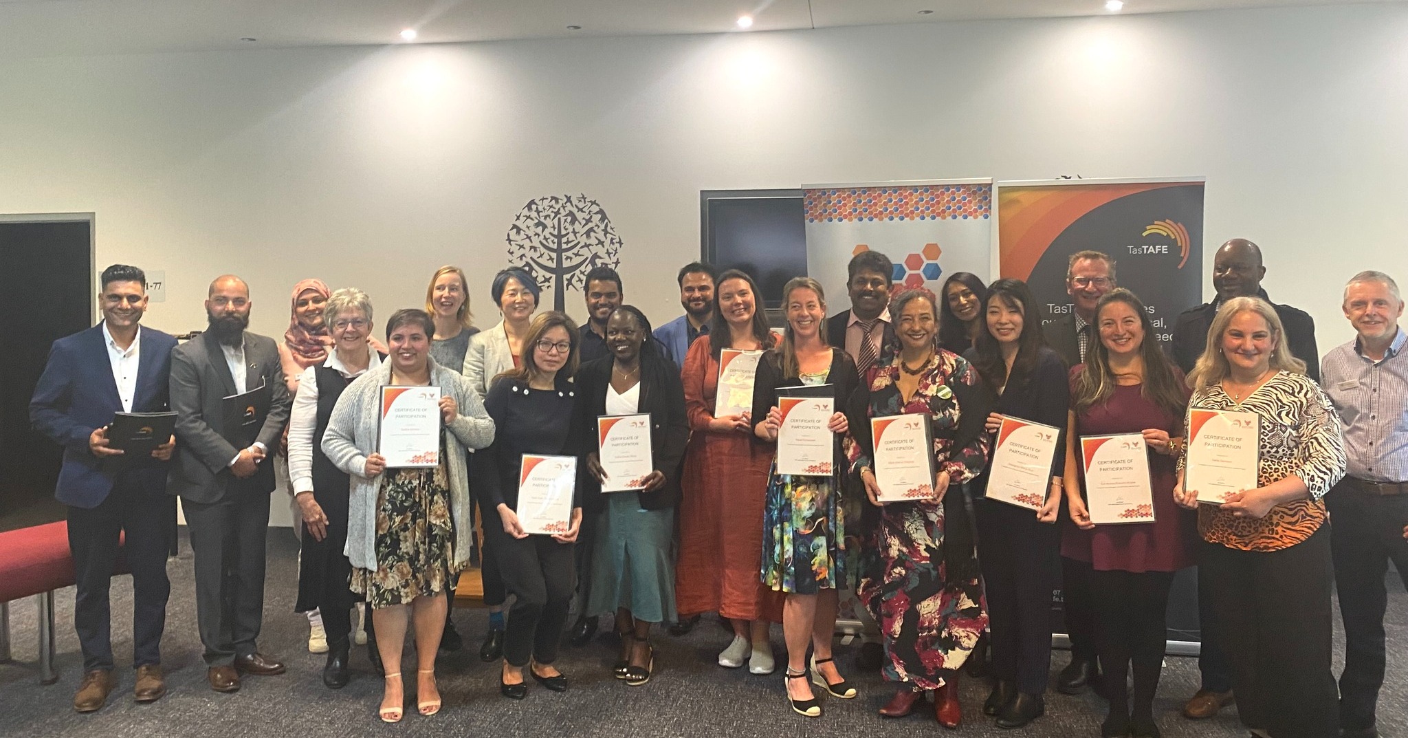 Group of diverse people holding certificates