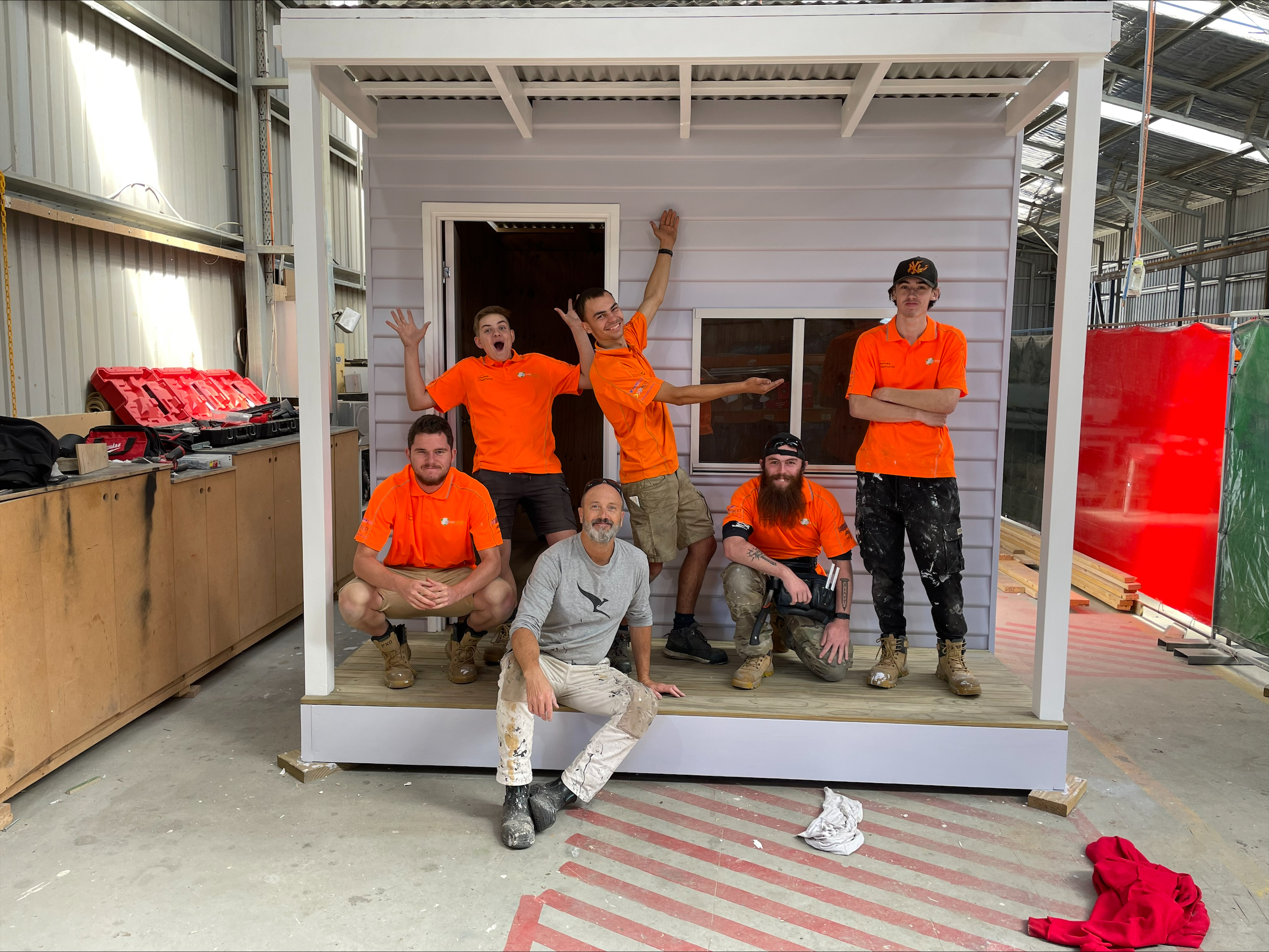 Podmatrix program participants pose outside the cubby pod