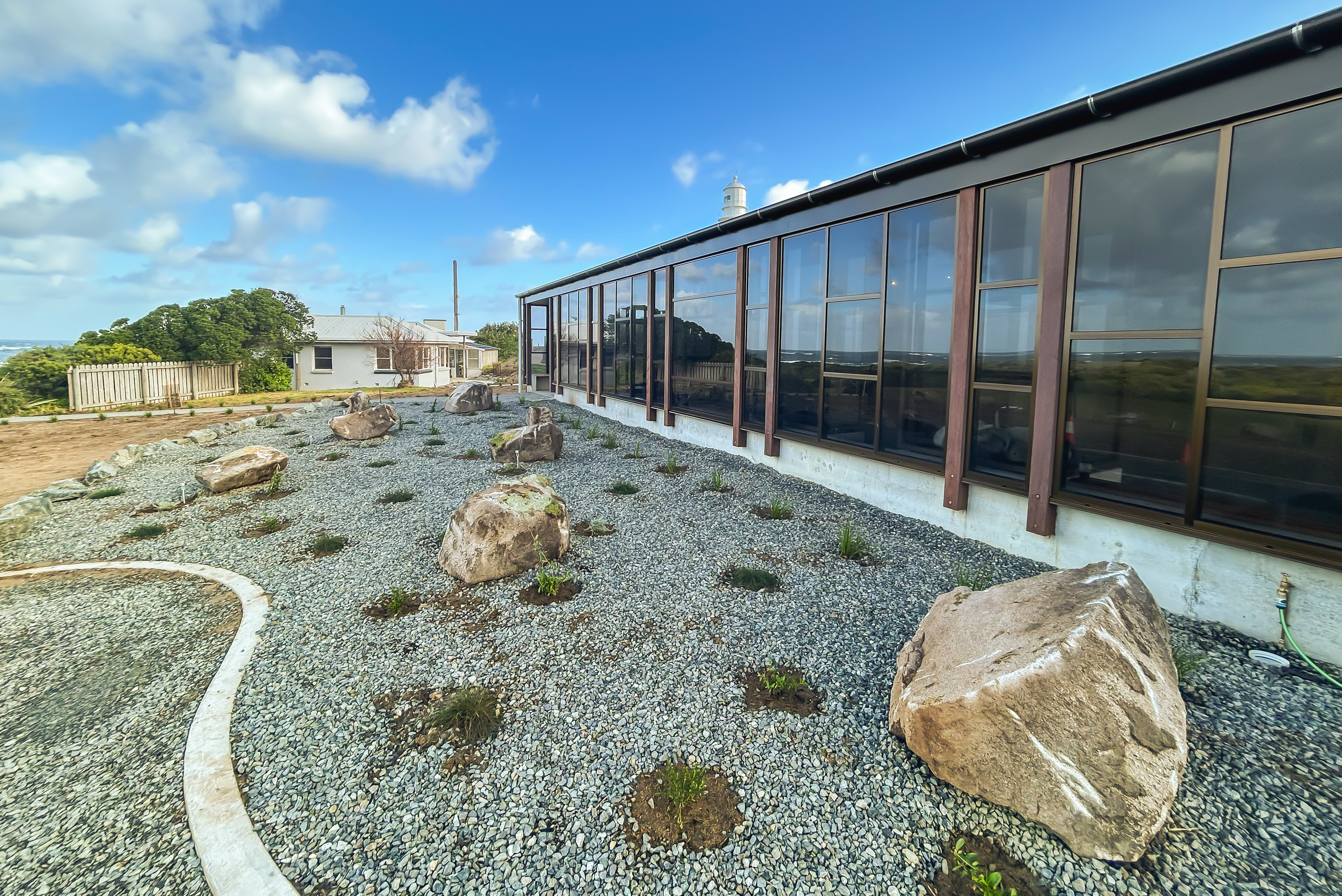 King island Study hub exterior with lots of windows and a garden infront