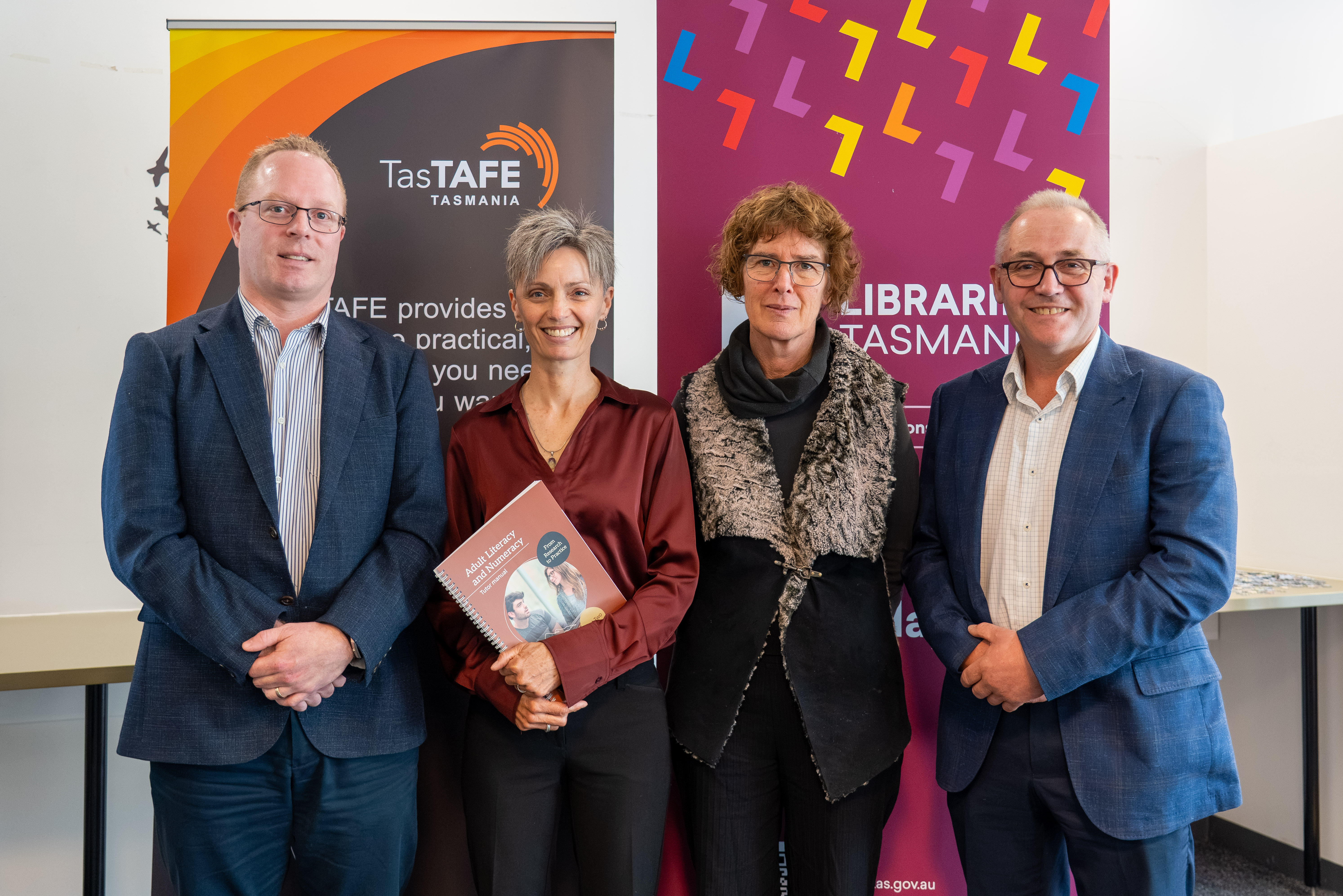 TasTAFE Interim CEO, Will McShane; Project Manager and TasTAFE Education Leader – Foundations, Kirrily Loveday; Libraries Tasmania Senior Literacy Advisor, Dr Iona Johnson; and Marcus Vermey MP at the launch of the Adult Literacy and Numeracy Tutor Manual at TasTAFE's Campbell Street Campus.