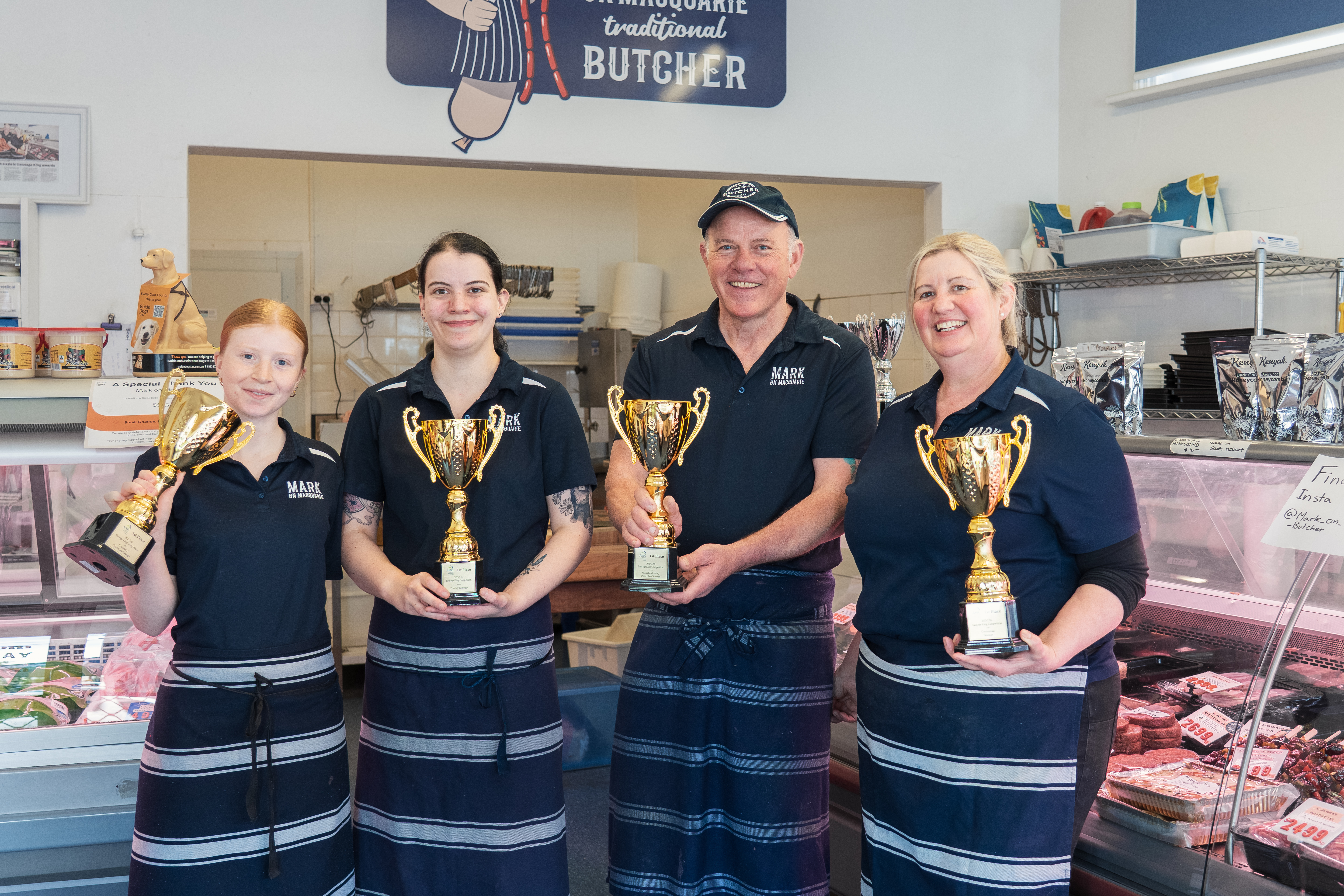 Abigail Lucas, Bronte Henshaw, Mark Henshaw and Michelle Henshaw at Mark on Macquarie Meats in South Hobart, with their 4 AMIC 2025 ‘Sausage King’ gold trophies.