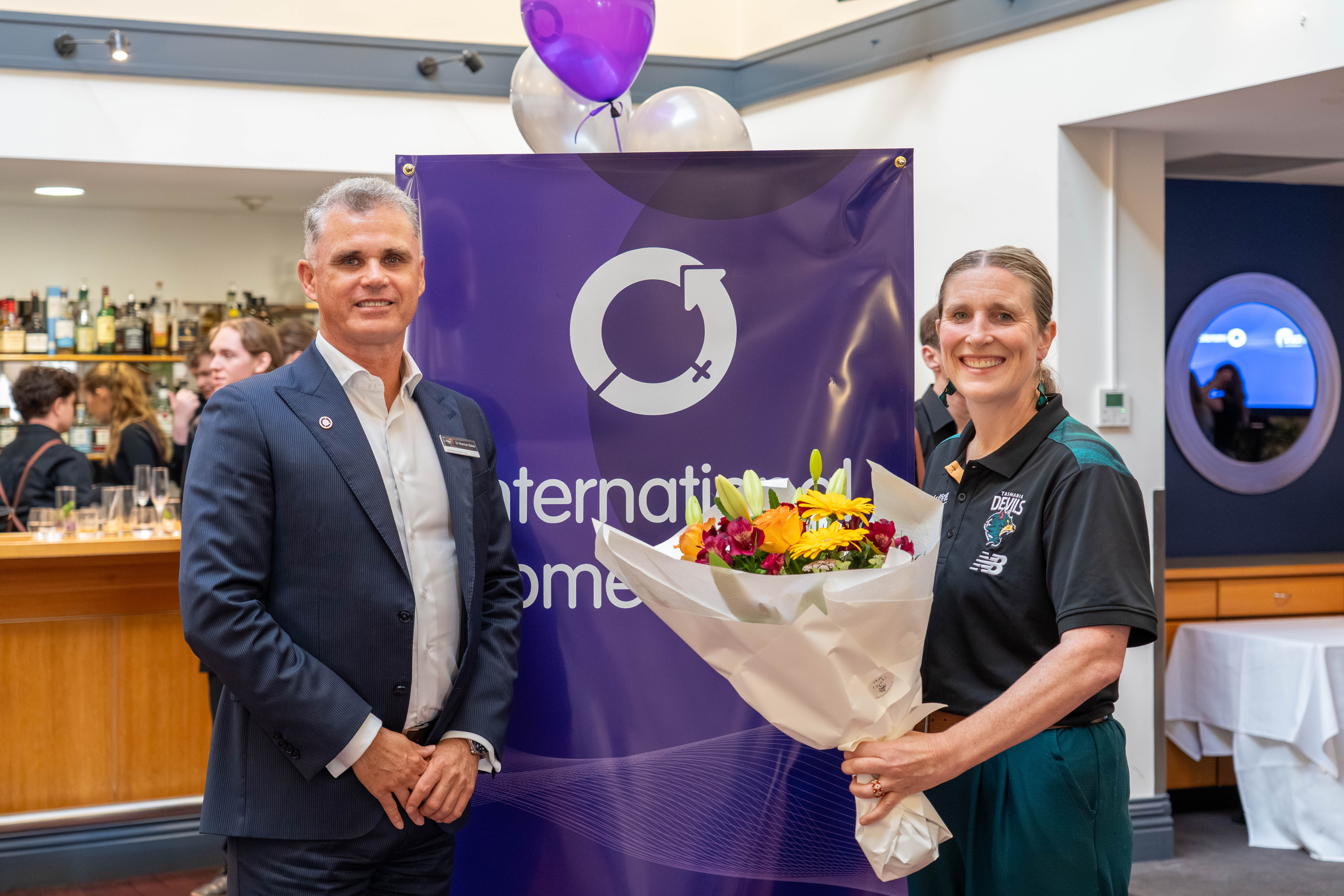 Dr Norman Baker, TasTAFE CEO, and Kath McCann, General Manager Marketing, Public Affairs and Social Impact with the Tasmania Football Club, at the TasTAFE International Women's Day event in Hobart.