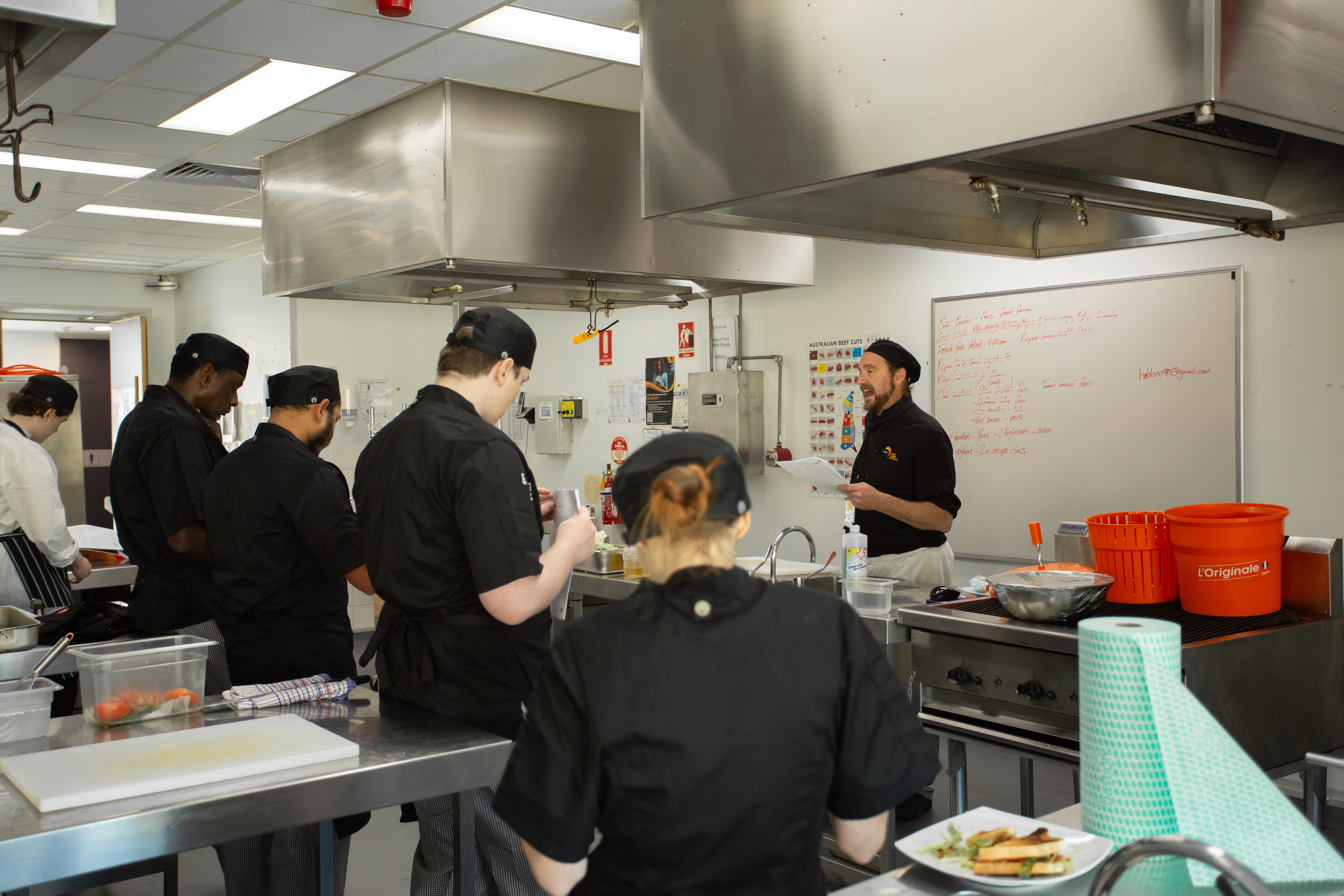 Cookery Teacher David Hobba instructing Kitchen Kickstart learners at TasTAFE’s Collins Street Campus.