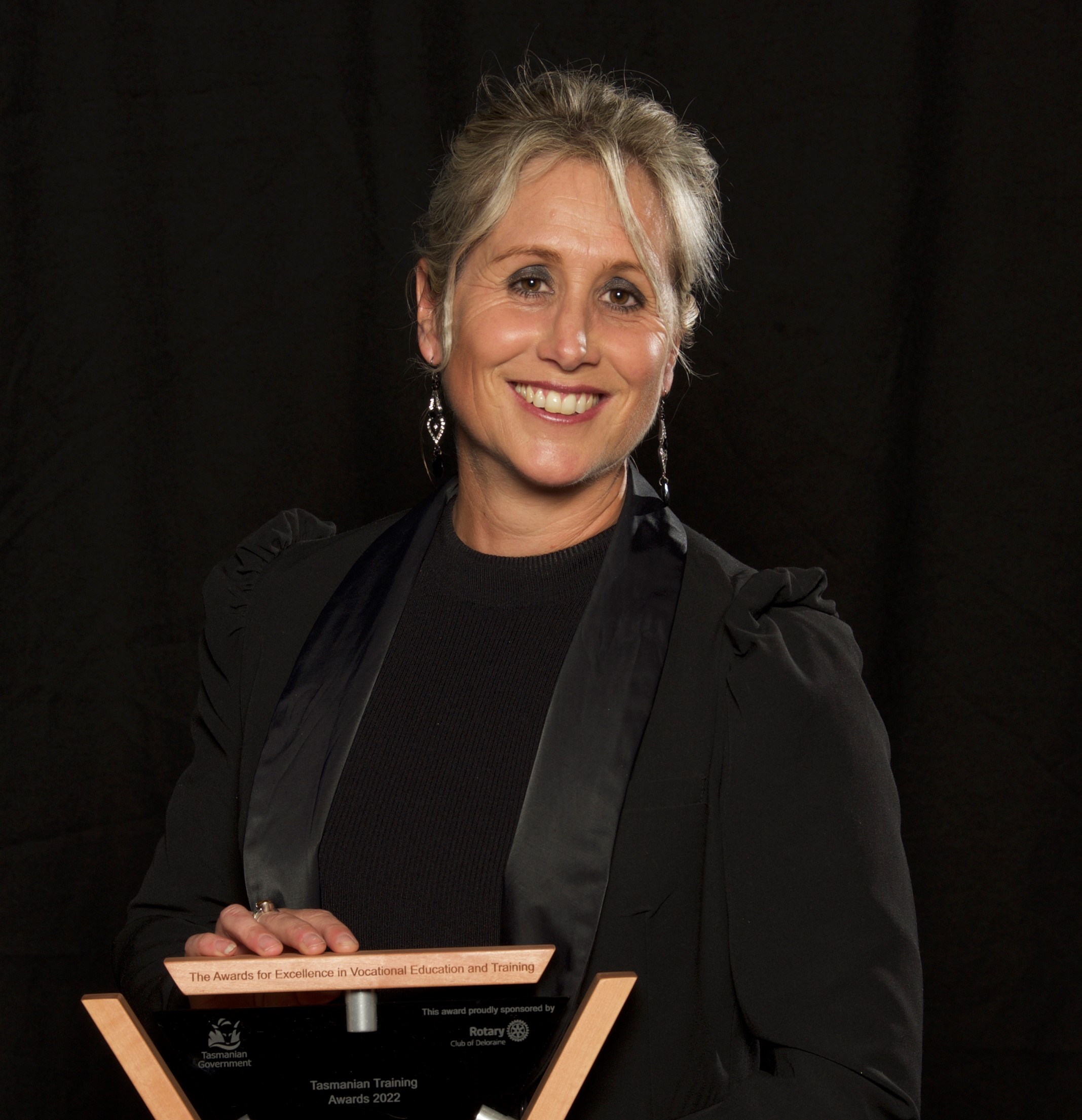 Fleur Broadhurst - Vocational Student of the Year posing with her trophy on a stool