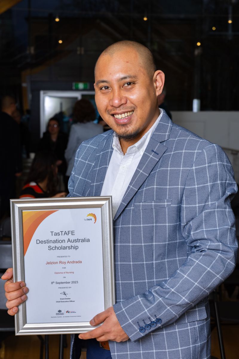 man holding a framed certificate