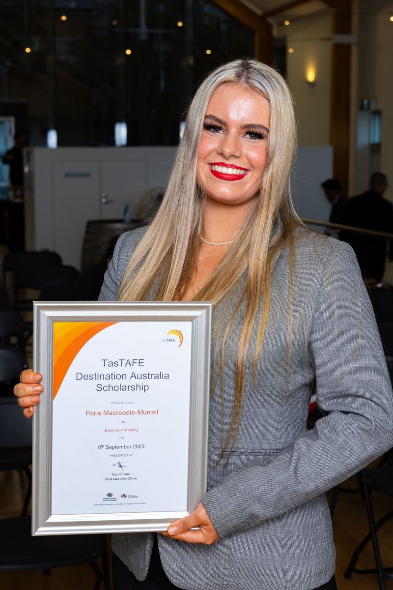 Woman holding a framed certificate