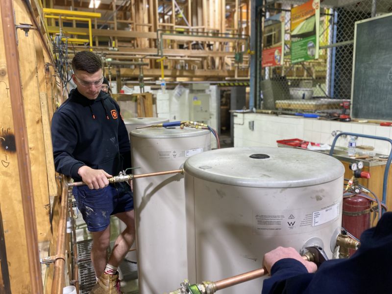 Student working on a hot water cylinder at the Claremont Plumbing Training Facility