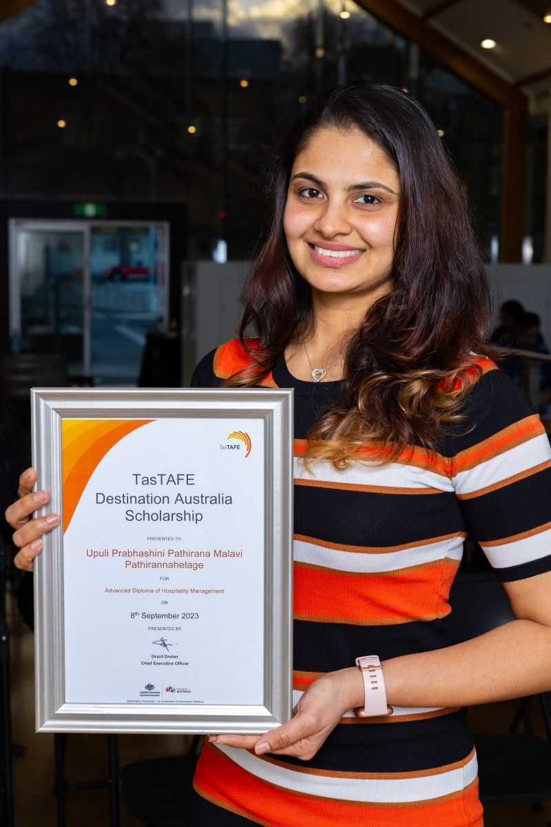 Woman holding a framed certificate