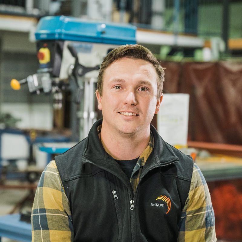 Plumbing teacher posing for a photo in the workshop