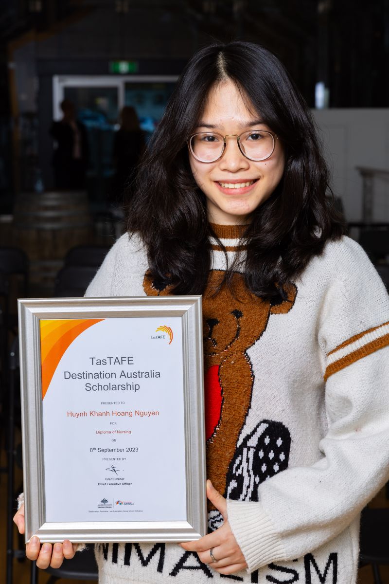 Woman holding a framed certificate