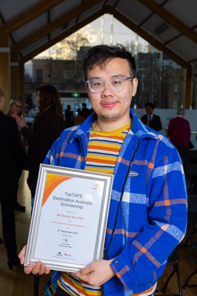 man holding a framed certificate