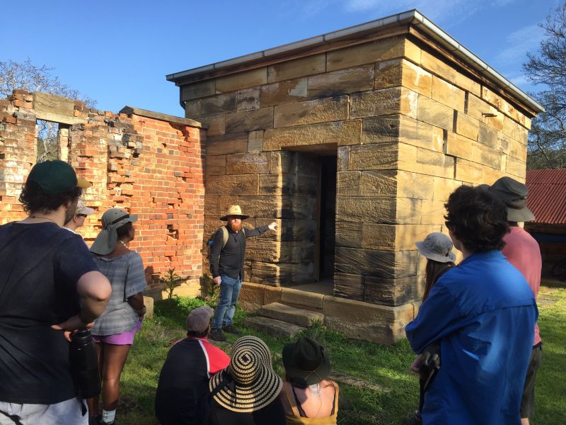 Tour group in front of a sone structure