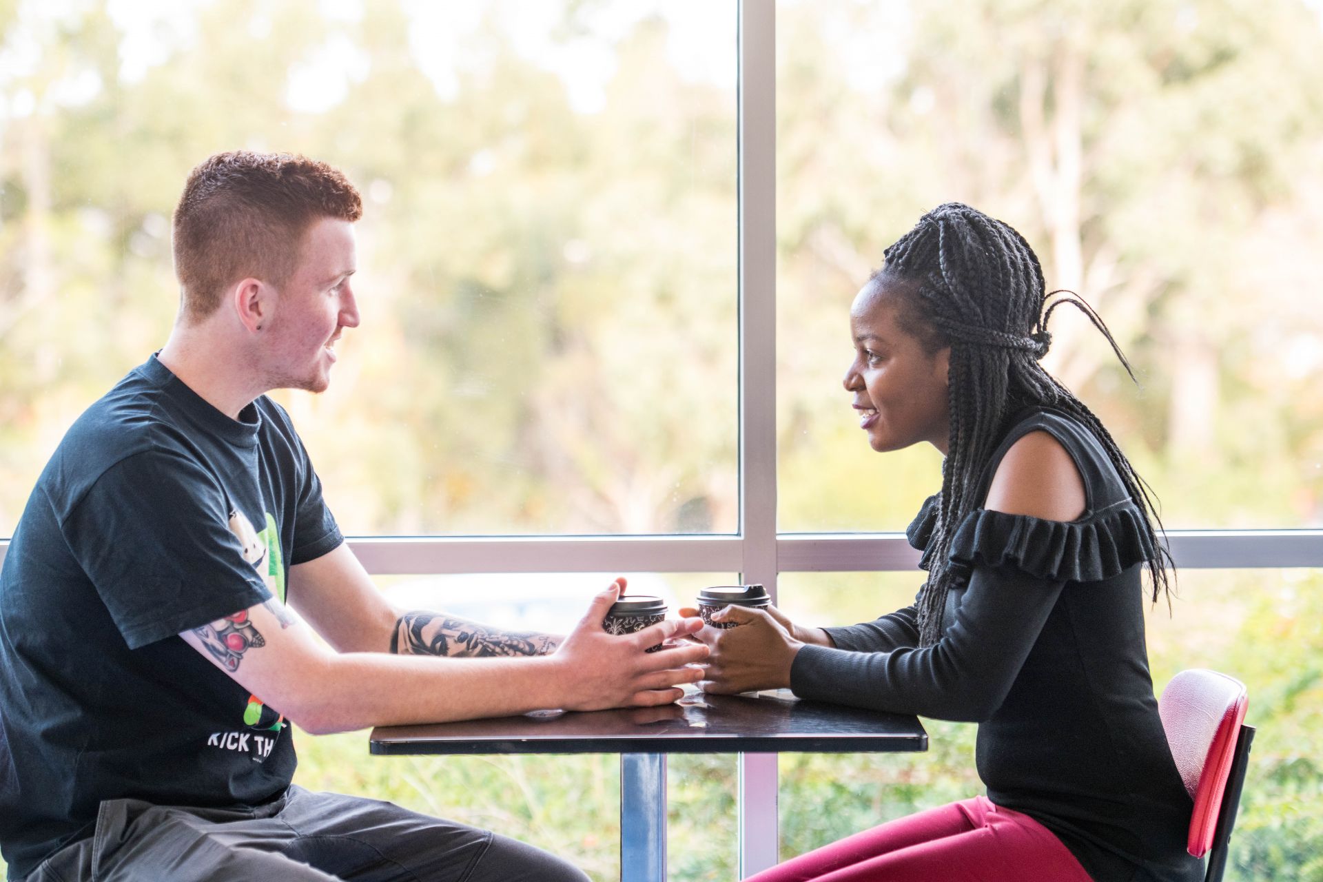 Man and woman sitting at a table in conversation