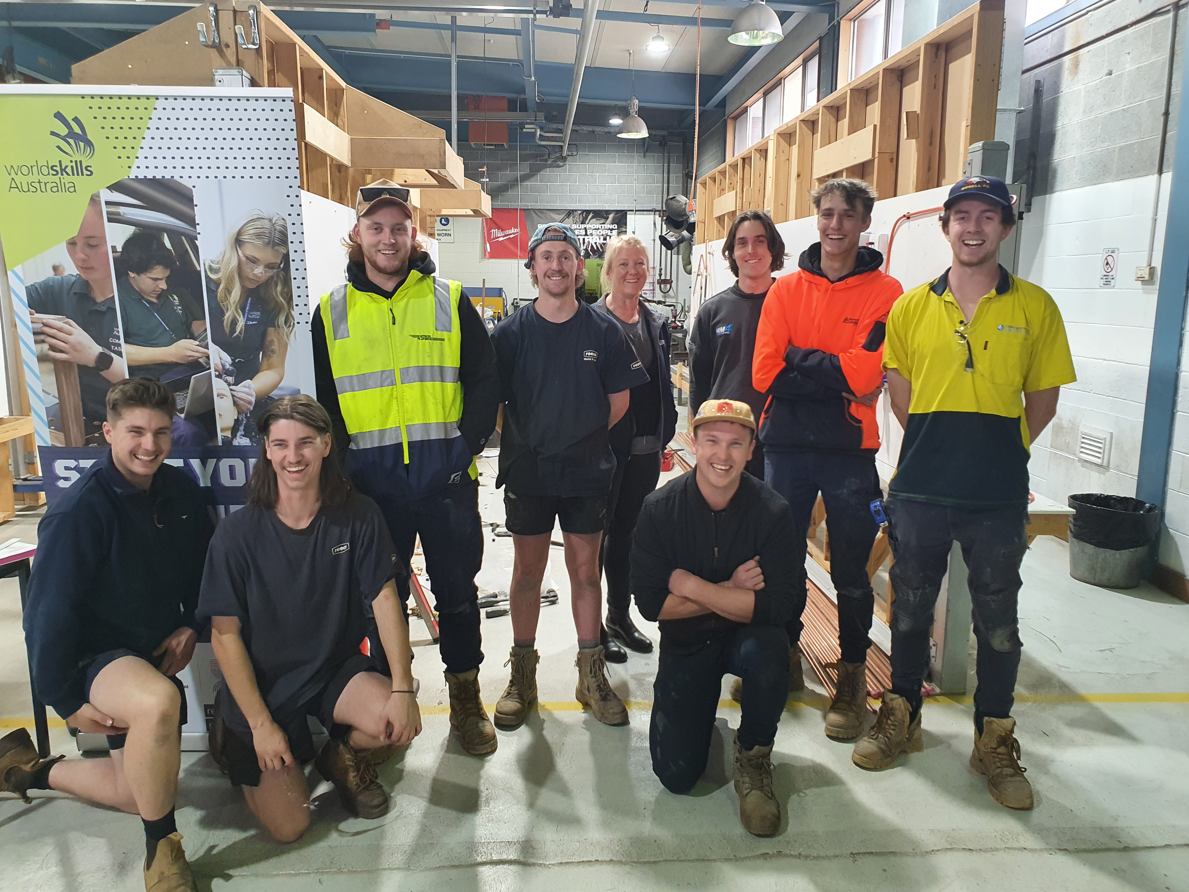 group photo in the plumbing and construction workshop