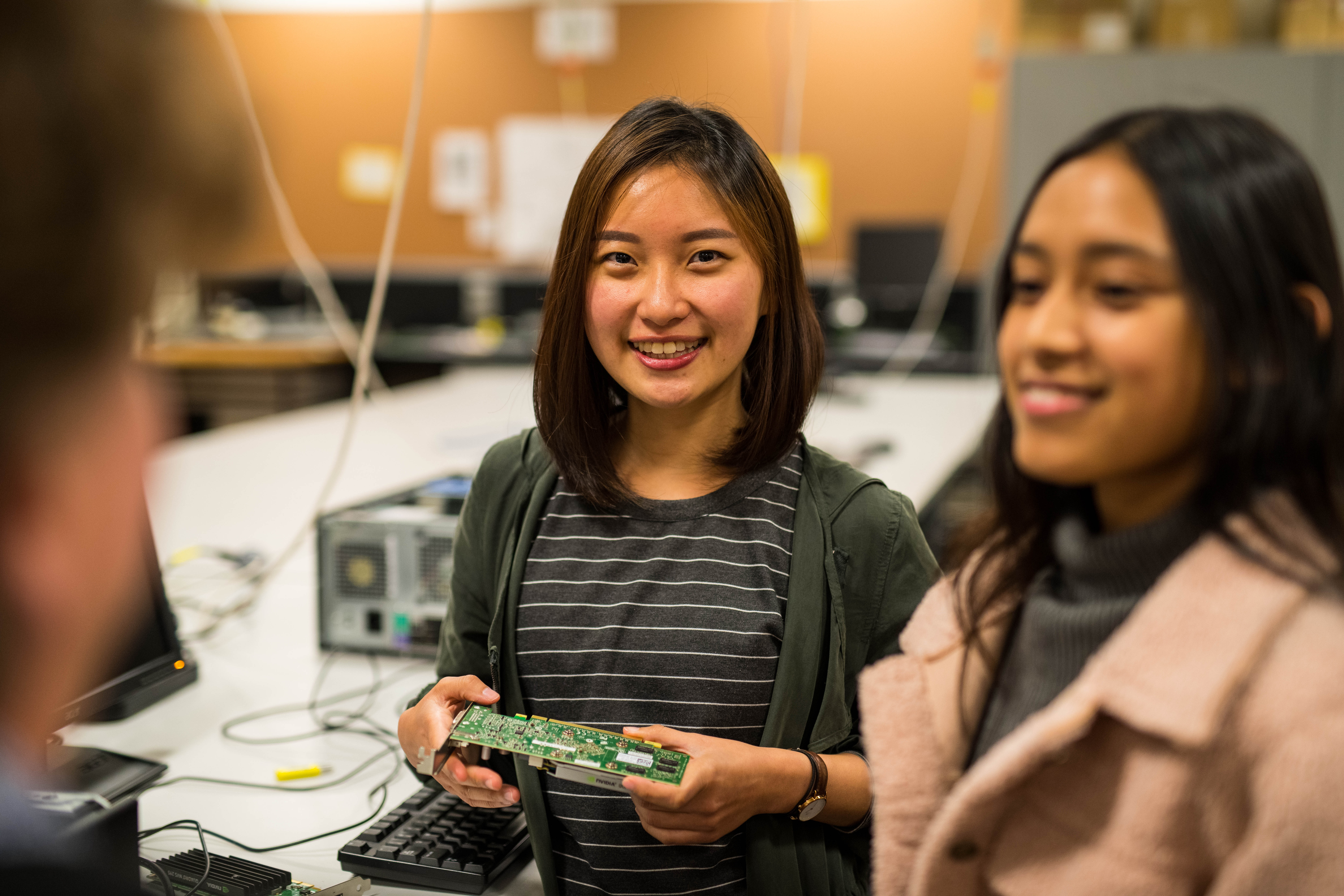ICT students posing for a photo holding a motherboard