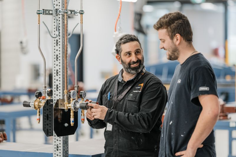 Plumbing teacher teaching a student in the plumbing classroom