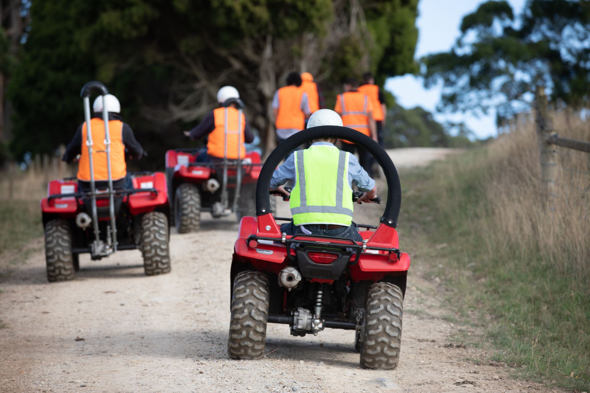 Quad bikes riding down the road at TasTAFE's Freer Farm during an Operate Quad bikes course.