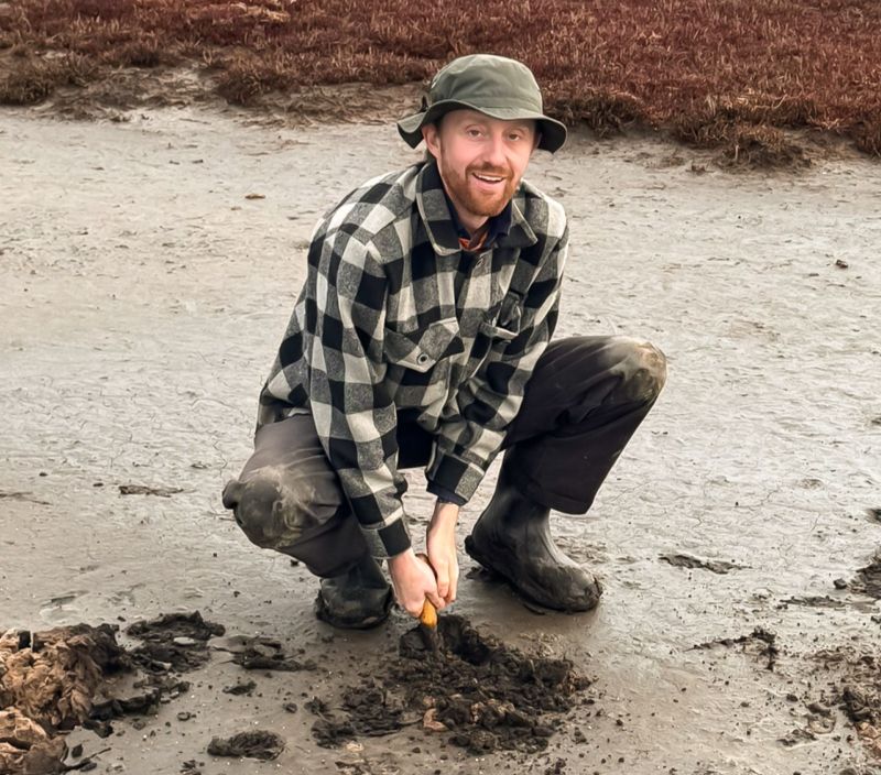 TasTAFE learner William Eastman digging into the earth using a small hand tool