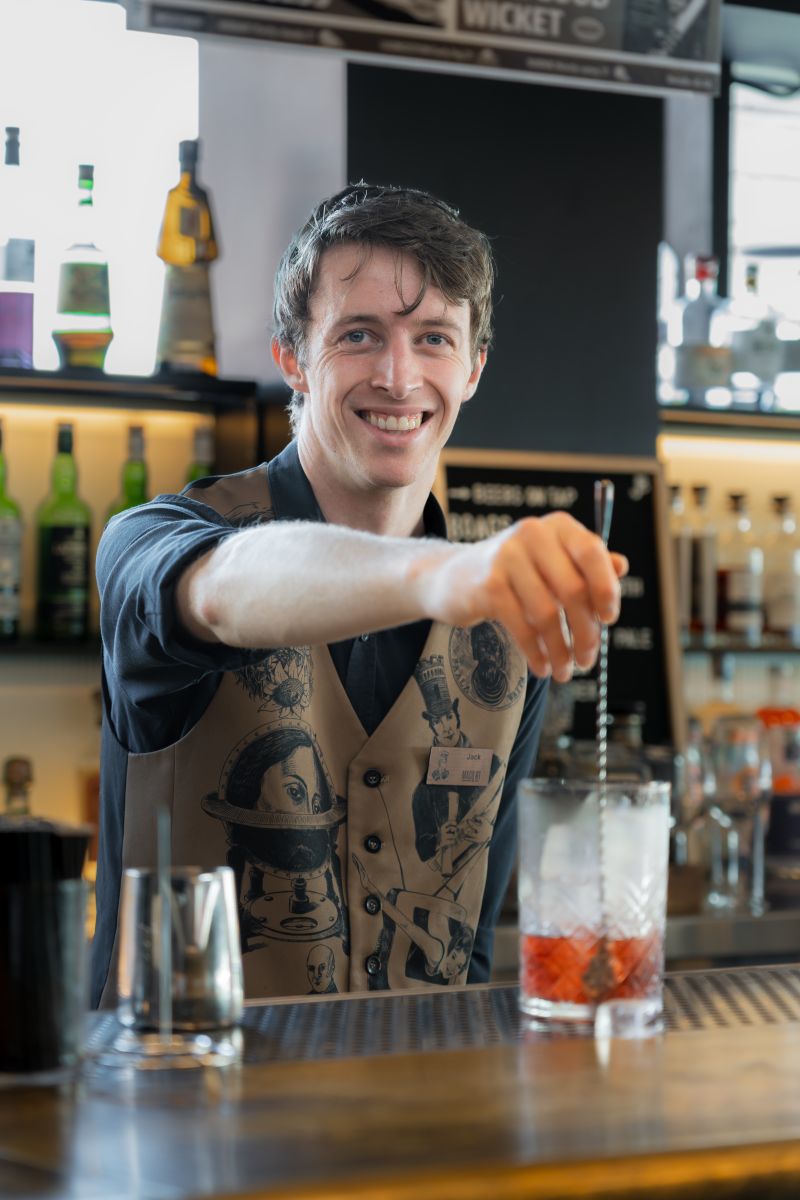 Bartender stirring a drink on the bar