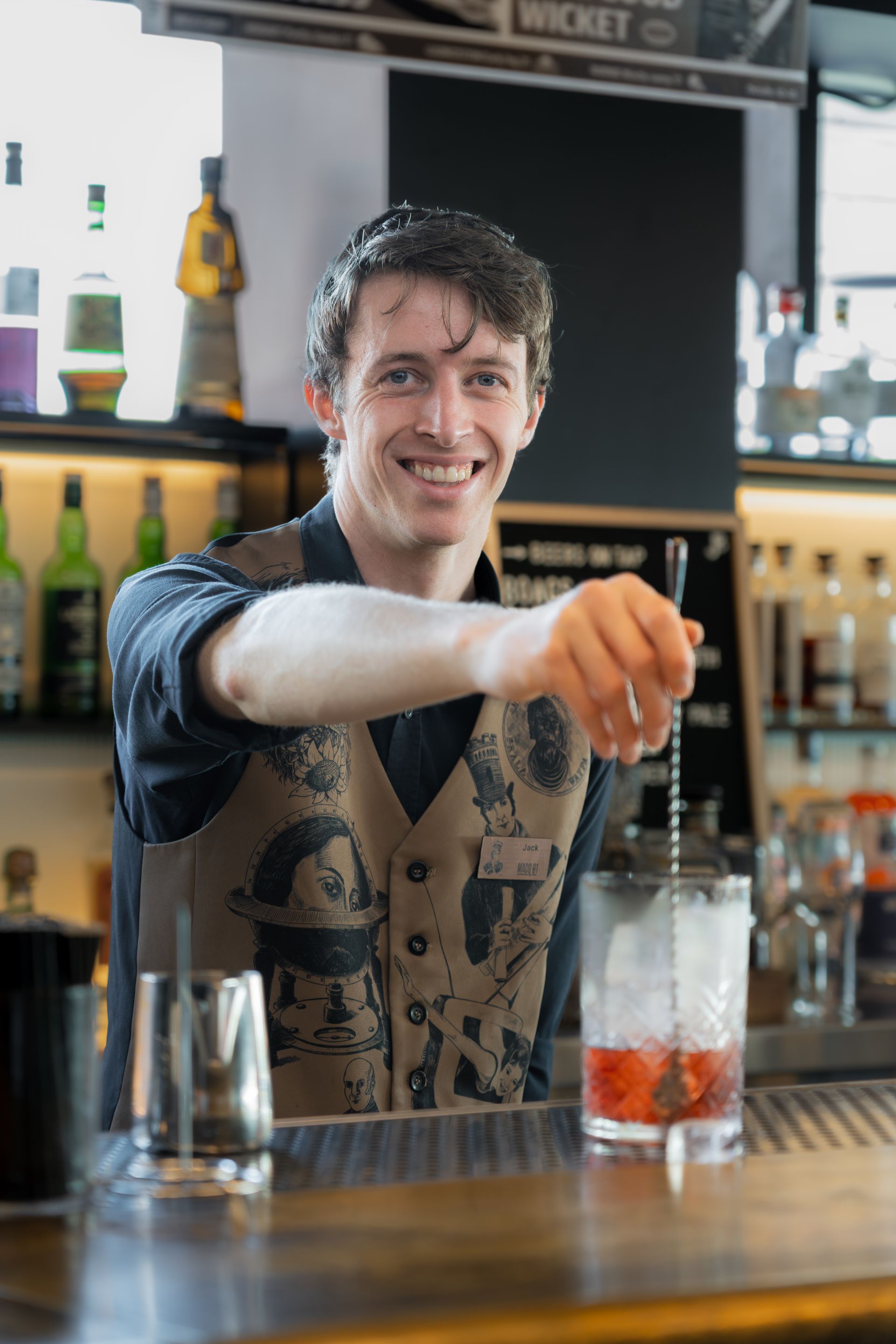 Bartender stirring a drink on the bar