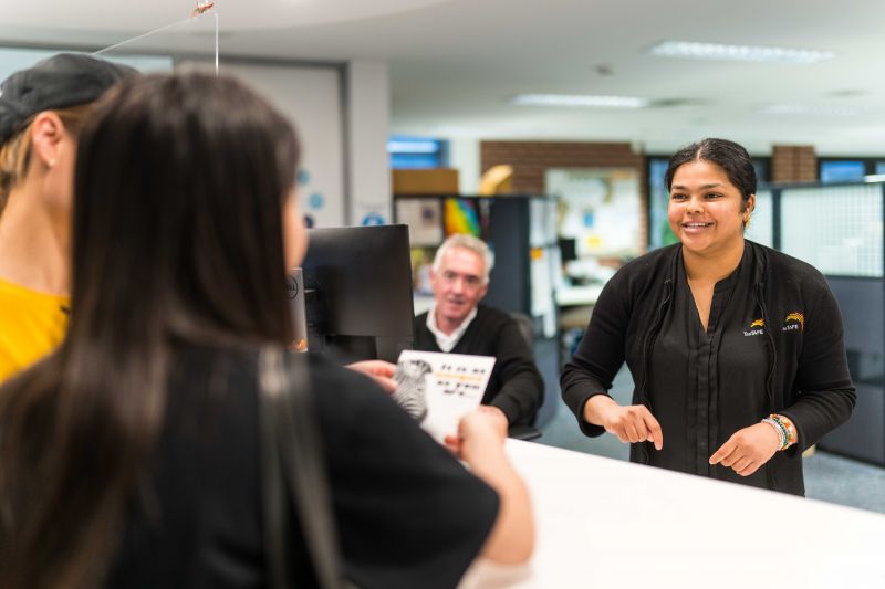 TasTAFE Client services staff welcoming a student
